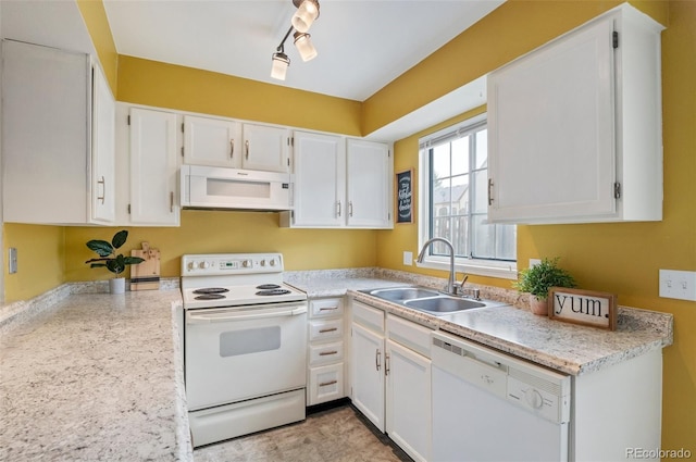 kitchen featuring light countertops, white appliances, white cabinets, and a sink