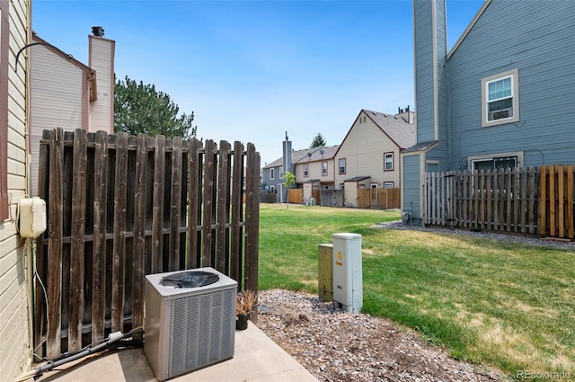 view of yard featuring central AC unit and a fenced backyard