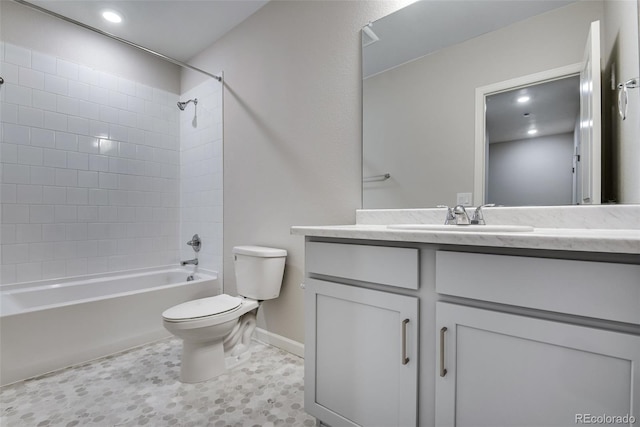 full bathroom featuring tile patterned floors, vanity, toilet, and tiled shower / bath combo