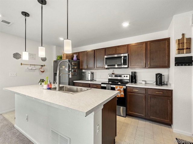 28314 E 6th Pl, Watkins, CO 80137 - kitchen featuring appliances with stainless steel finishes, a sink, light countertops, baseboards, and dark brown cabinets