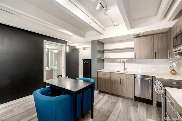 1495 Vrain St Unit 110, Denver, CO 80204 - kitchen with stainless steel appliances, open shelves, light wood-style floors, tasteful backsplash, and track lighting