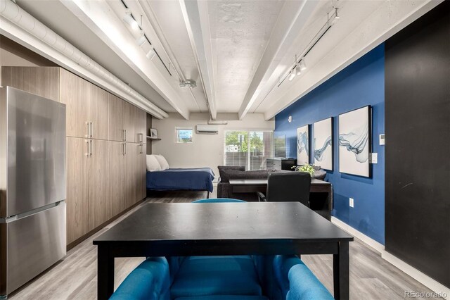 1495 Vrain St Unit 110, Denver, CO 80204 - game room with light wood finished floors, a wall mounted air conditioner, rail lighting, and beam ceiling