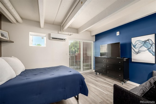 1495 Vrain St Unit 110, Denver, CO 80204 - bedroom with beam ceiling, a wall mounted air conditioner, and light wood-style floors