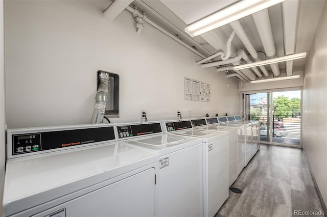 1495 Vrain St Unit 110, Denver, CO 80204 - communal laundry room with separate washer and dryer and light wood-style floors
