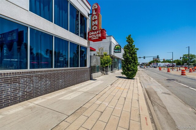 1495 Vrain St Unit 110, Denver, CO 80204 - view of asphalt street with traffic lights, sidewalks, curbs, and street lighting