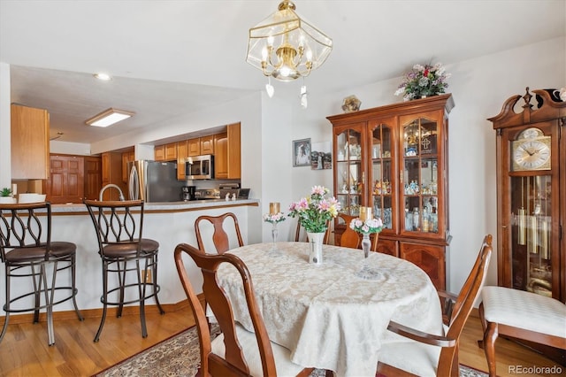 dining room with a chandelier and light wood-style floors