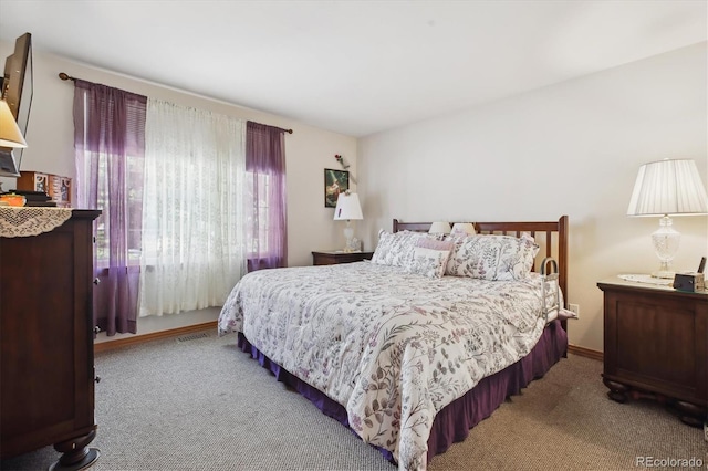 bedroom featuring carpet and baseboards