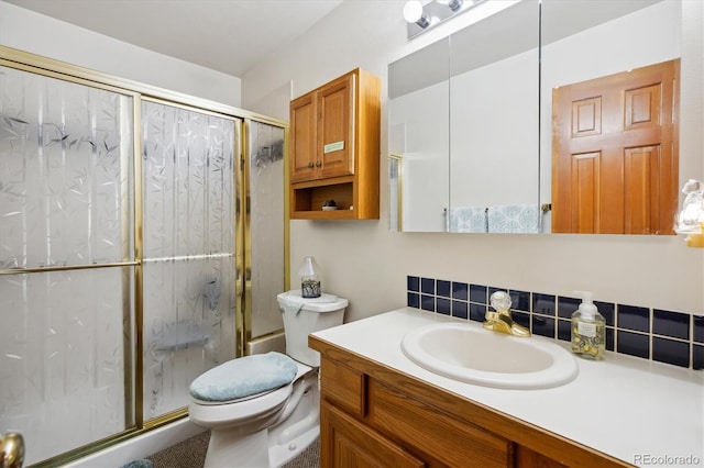 bathroom with a shower stall, toilet, tasteful backsplash, and vanity