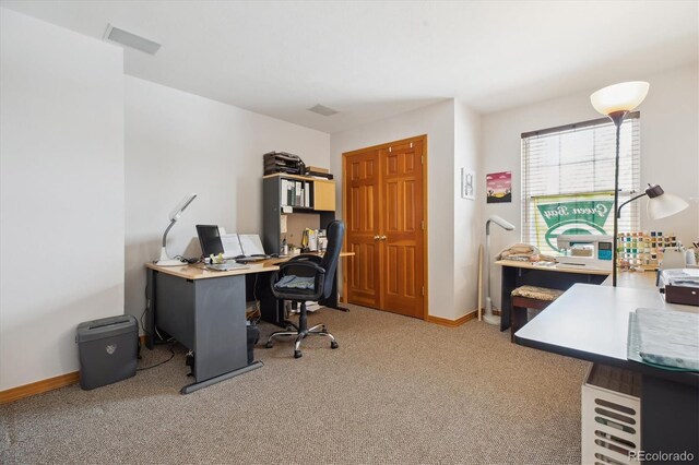 home office with light carpet, visible vents, and baseboards