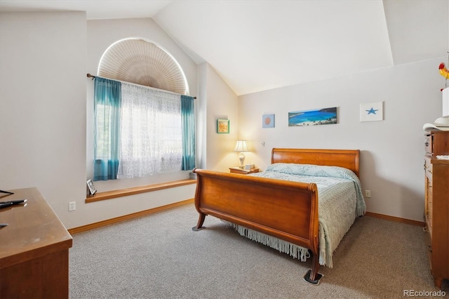bedroom featuring vaulted ceiling, carpet floors, and baseboards