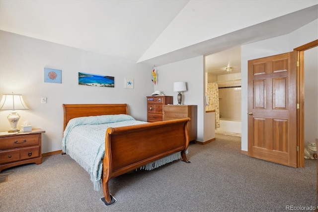 bedroom with light carpet, vaulted ceiling, ensuite bath, and baseboards