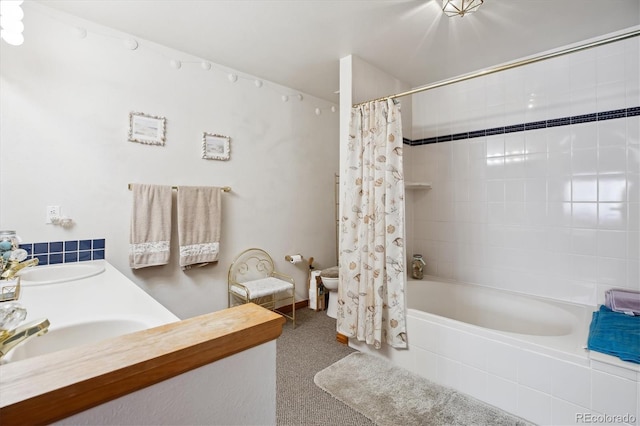 full bath featuring double vanity, shower / bathtub combination with curtain, toilet, and a sink
