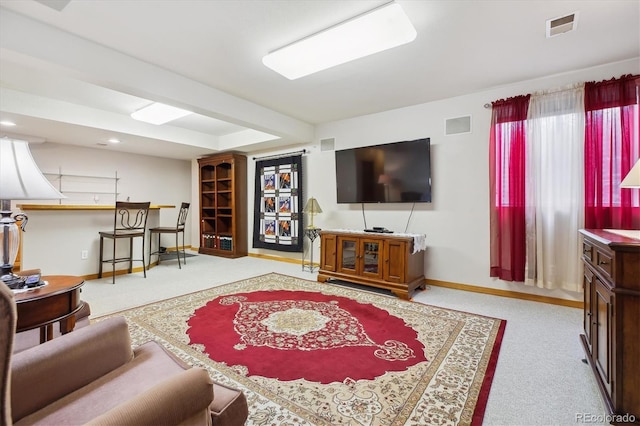 carpeted living area featuring recessed lighting, visible vents, and baseboards