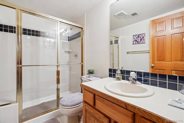 bathroom with toilet, visible vents, and a stall shower