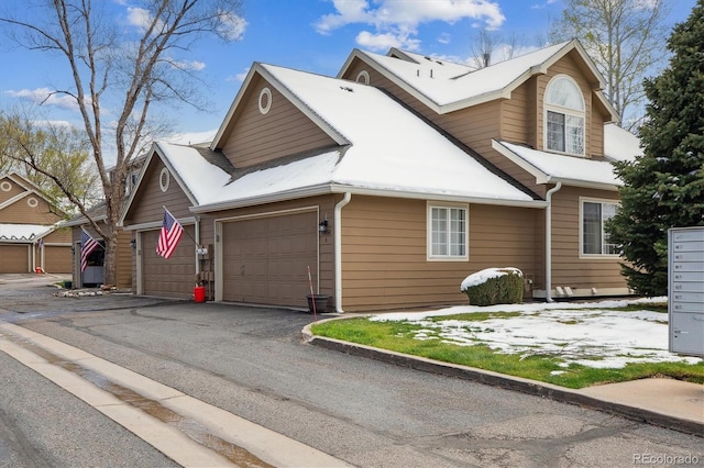 view of front of house featuring aphalt driveway and a garage