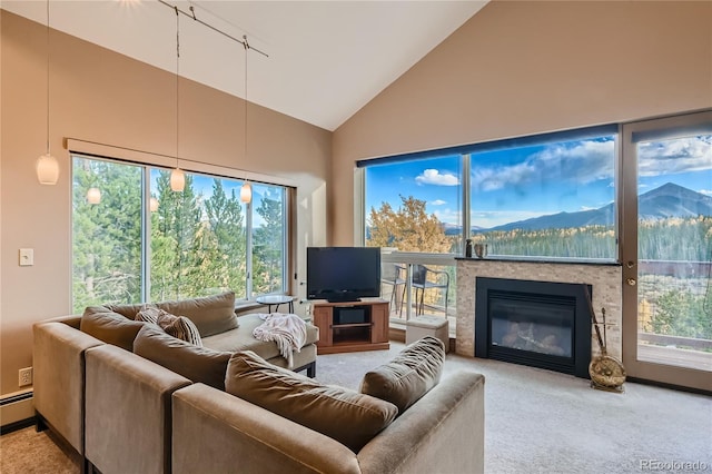 carpeted living room featuring plenty of natural light and high vaulted ceiling