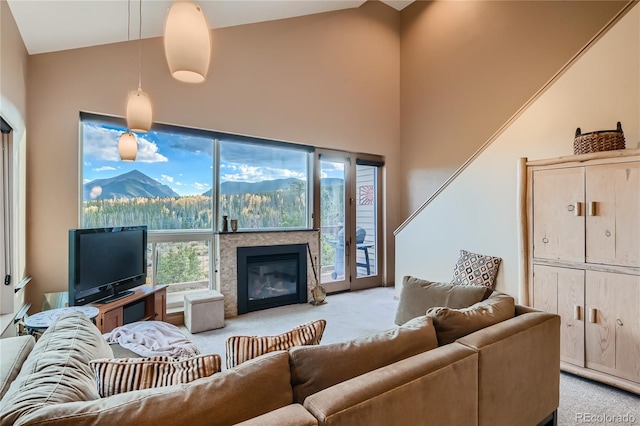 carpeted living room with high vaulted ceiling