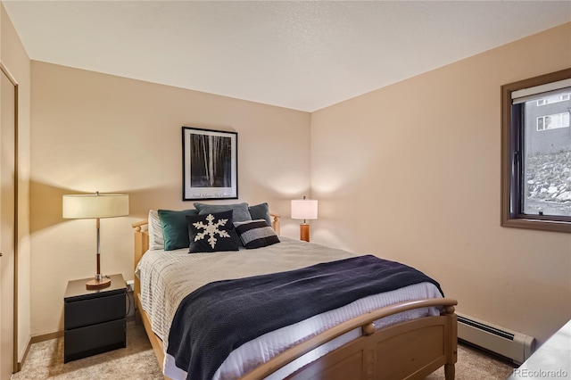 carpeted bedroom featuring baseboard heating