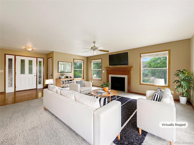642 52nd Ave, Greeley, CO 80634 - living room featuring healthy amount of natural light, a ceiling fan, and a fireplace