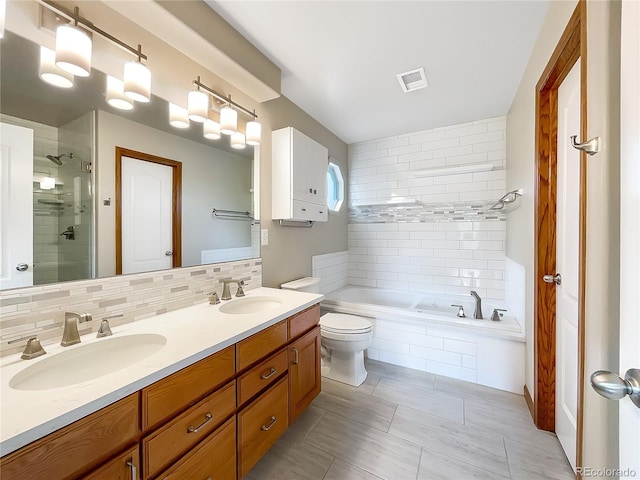 642 52nd Ave, Greeley, CO 80634 - bathroom featuring double vanity, a bath, a shower stall, and backsplash