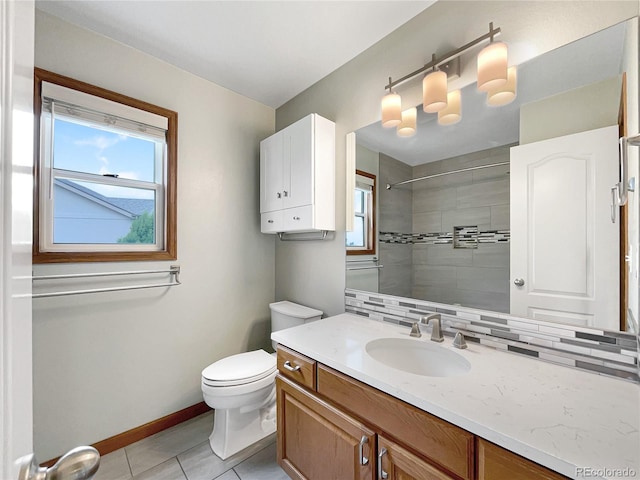 642 52nd Ave, Greeley, CO 80634 - full bathroom with healthy amount of natural light, a tile shower, vanity, and tile patterned floors