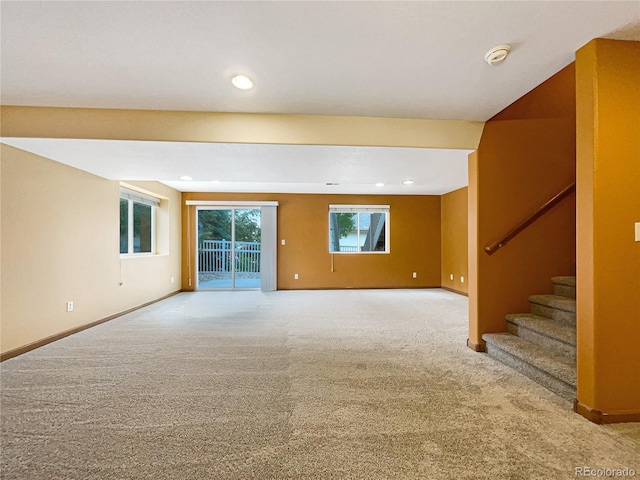 642 52nd Ave, Greeley, CO 80634 - unfurnished living room with light colored carpet, stairs, and recessed lighting