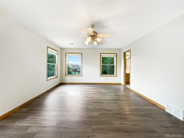 642 52nd Ave, Greeley, CO 80634 - empty room featuring plenty of natural light, a ceiling fan, and dark wood-style flooring
