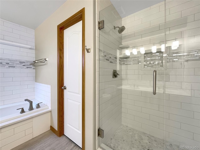 642 52nd Ave, Greeley, CO 80634 - full bath featuring a stall shower, wood finished floors, and a garden tub