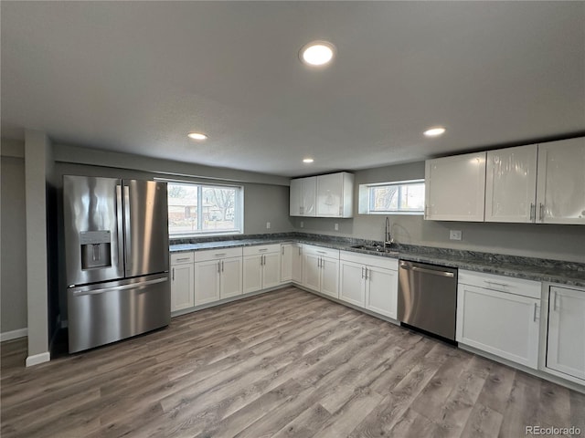 kitchen with a healthy amount of sunlight, stainless steel appliances, recessed lighting, and a sink