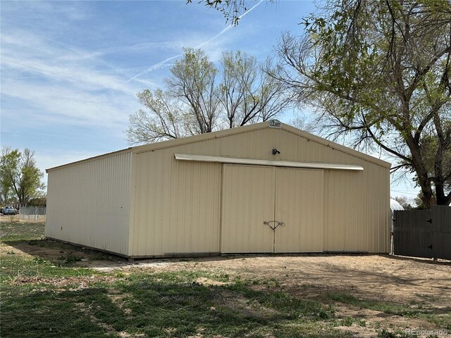 view of pole building featuring fence