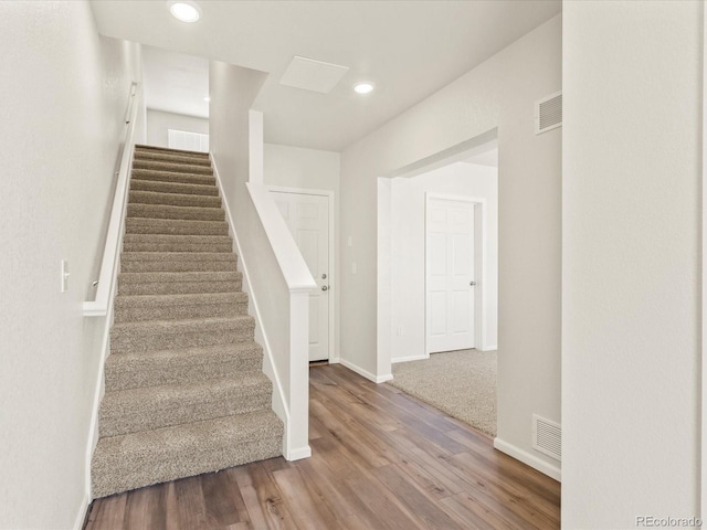 stairs featuring wood-type flooring