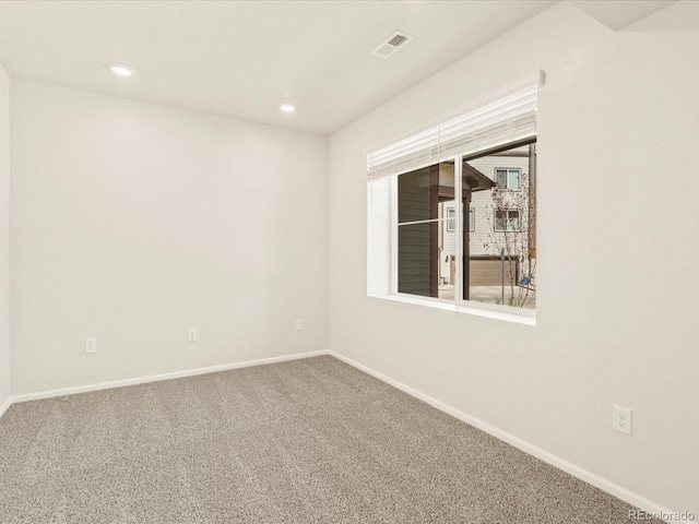 unfurnished room featuring carpet