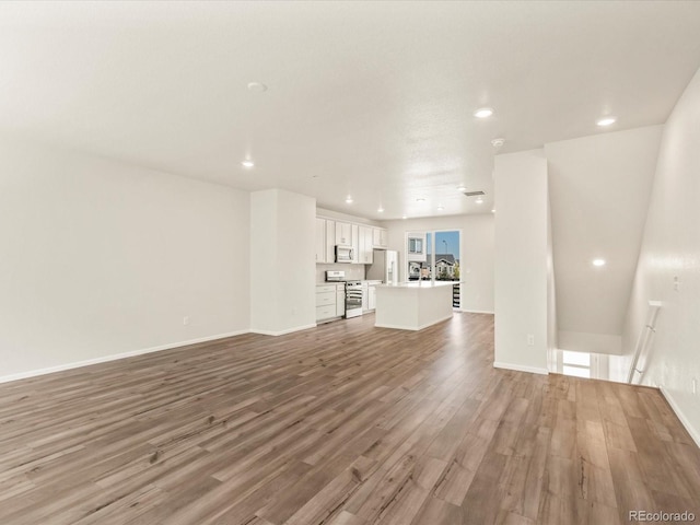 unfurnished living room featuring hardwood / wood-style floors