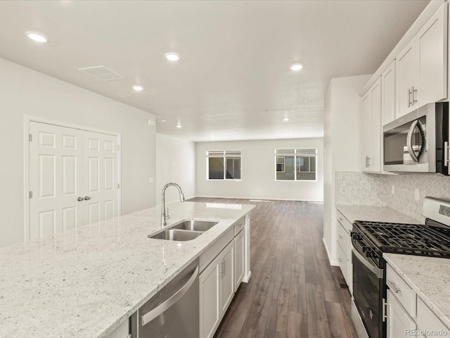 kitchen featuring light stone counters, appliances with stainless steel finishes, sink, and white cabinets