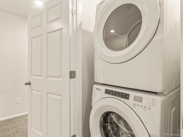 washroom featuring stacked washer / dryer and carpet