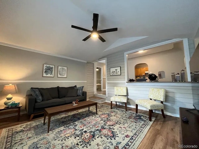 living room with ceiling fan, vaulted ceiling, and hardwood / wood-style flooring