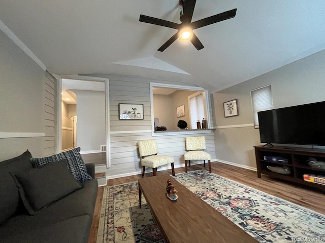 living room featuring ceiling fan, lofted ceiling, and hardwood / wood-style flooring