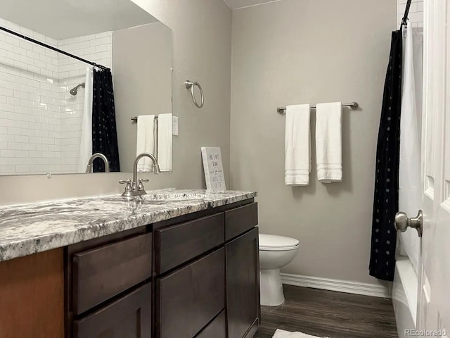 bathroom with vanity, hardwood / wood-style flooring, and toilet