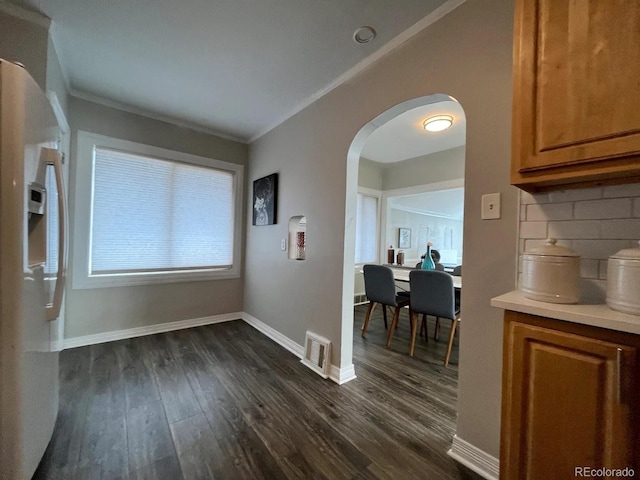 dining room featuring crown molding and dark hardwood / wood-style flooring