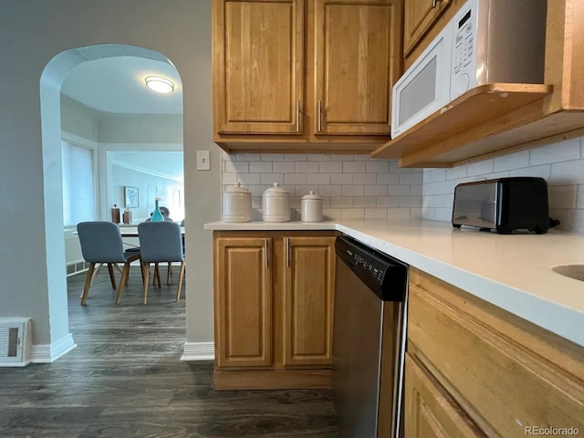 kitchen with tasteful backsplash, stainless steel dishwasher, and dark hardwood / wood-style floors