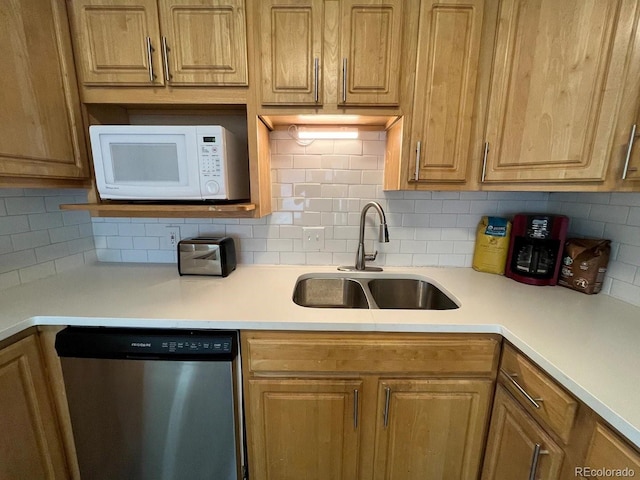 kitchen featuring dishwasher, tasteful backsplash, and sink