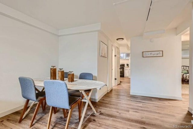 dining space with light hardwood / wood-style flooring