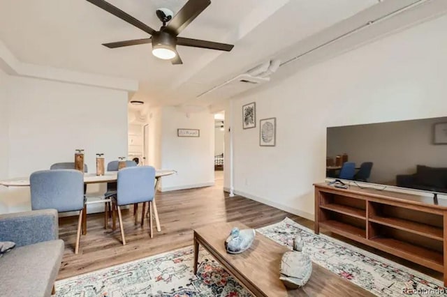 living room featuring ceiling fan and light hardwood / wood-style flooring