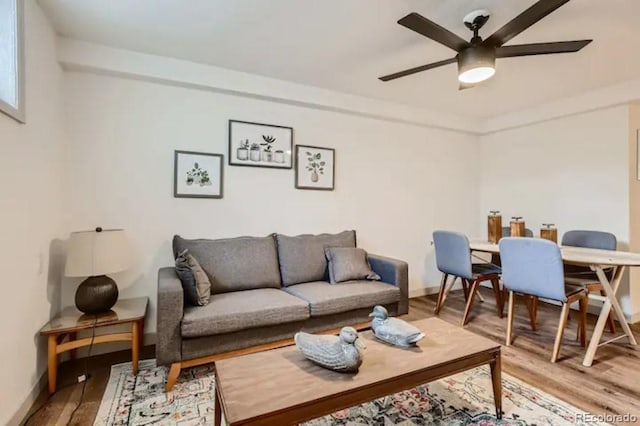 living room with hardwood / wood-style floors and ceiling fan