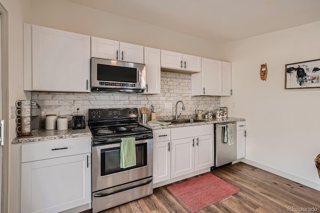 kitchen featuring white cabinetry, stainless steel appliances, and light wood-type flooring