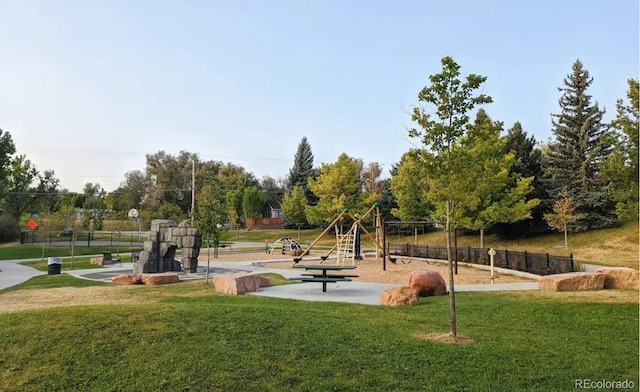 view of property's community featuring a yard and a playground