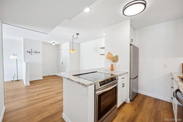 kitchen featuring pendant lighting, white cabinetry, light stone counters, kitchen peninsula, and stainless steel appliances