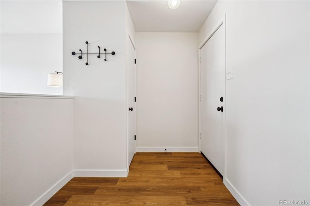 corridor with wood-type flooring