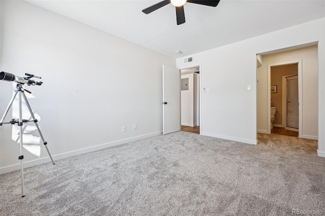 unfurnished bedroom featuring ensuite bathroom, carpet flooring, and ceiling fan