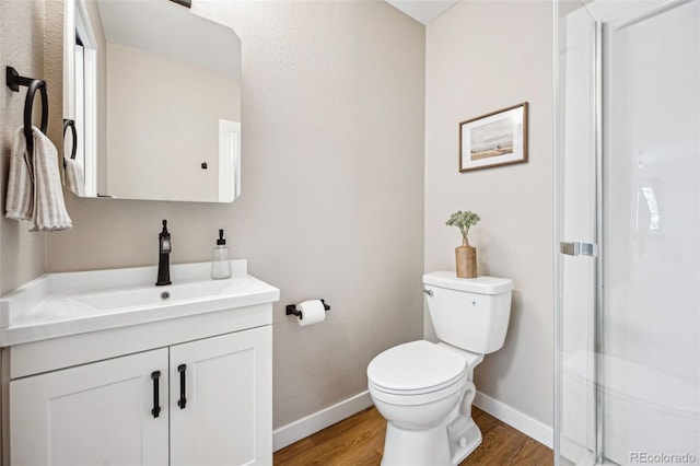 bathroom featuring vanity, toilet, and hardwood / wood-style floors